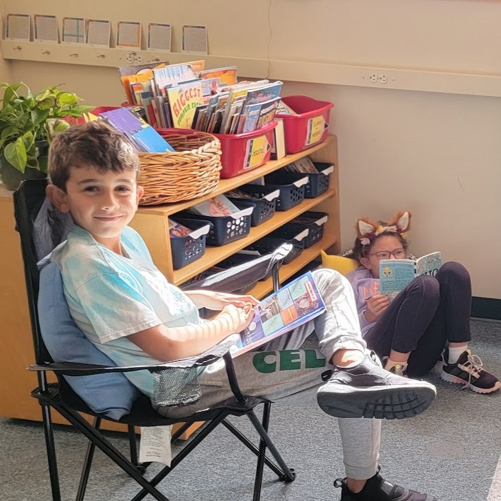 Student sitting in a chair reading